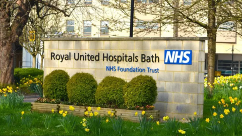 A named stone wall with Royal United Hospitals Bath NHS and NHS Foundation Trust written on it. 