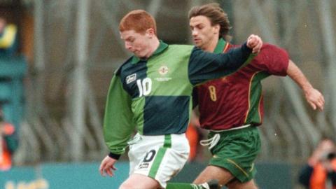 Neil Lennon playing in green Northern Ireland shirt in a match against Portugal in 1997