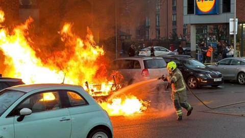Firefighters tackle car fire