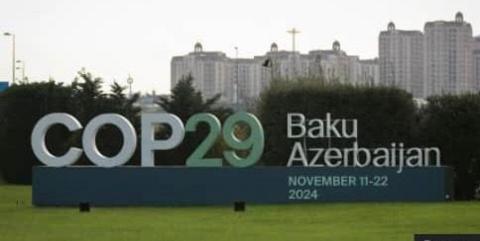 COP29 sign with a backdrop of the cityscape in Baku, Azerbaijan