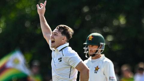 Curtis Campher clebrates taking a Zimbabwe wicket