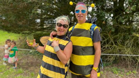 A man and woman dressed up as bees at WOMAD Festival