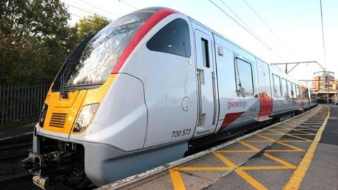 The front of a Greater Anglia train waiting at a platform