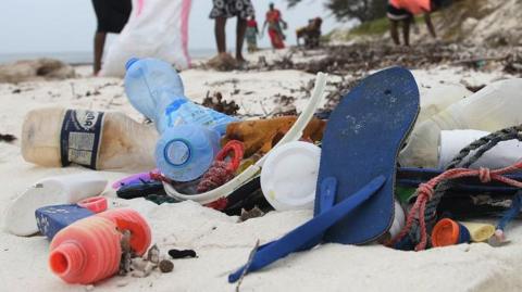 a beach with plastic pollution