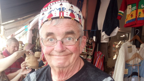 Mike Knight is pictured with spectacles and a hat. He is looking at the camera.