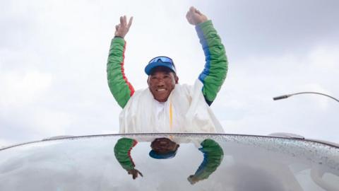 Legendary Mountaineer Kami Rita Sherpa waves at people as he arrives after scaling Mt Everest in 2024