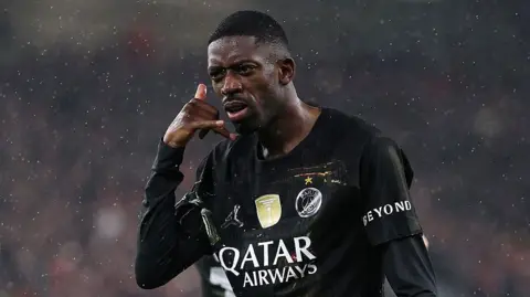 PSG's Ousmane Dembele celebrates scoring against Liverpool at Anfield
