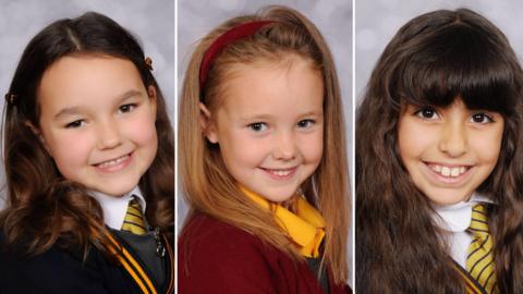 A composite image of Elsie Dot Stancombe, Alice da Silva Aguiar, and Bebe King. The three girls are all smiling as they pose for the camera. Elsie Dot Stancombe is wearing her maroon and yellow school uniform, Alice da Silva Aguiar is wearing a white dress and Bebe King is wearing a charcoal-coloured top.
