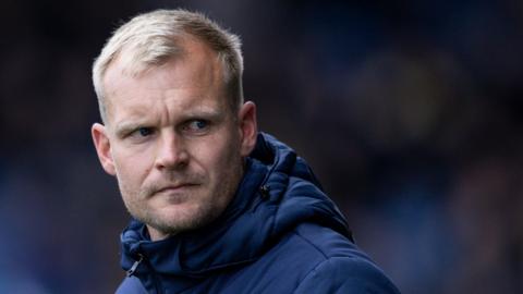 Oxford United boss Liam Manning looking tense on the touchline.