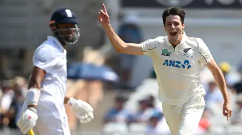 New Zealand fast bowler Will O'Rourke (right) celebrates taking the wicket of England batter Emilio Gay (left)