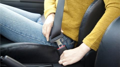 Woman fastening seatbelt