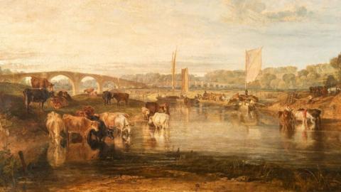 JMW Turner Walton Bridges, c1806, oil on canvas, showing a figurative landscape with a herd of cows, some drinking in water, others on the shore, boats and people in the middle distance and beyond a double-span bridge, trees and a cloudy and light blue sky