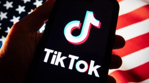  In this photo illustration a smartphone screen displays the logo of social media app TikTok 