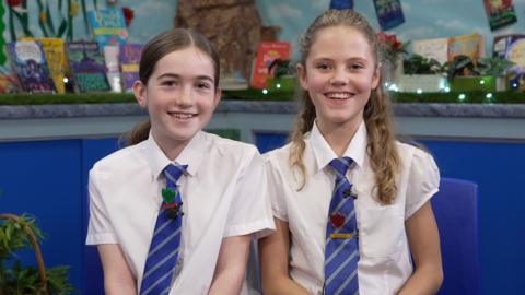 Two school children smiling at the camera