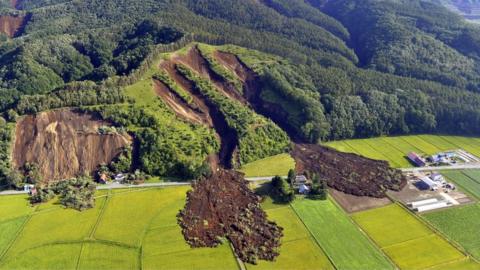 Houses destroyed by a large mudslide on a hillside