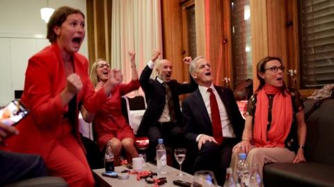 Norway's Labour leader Jonas Gahr Store cheers after seeing the exit poll