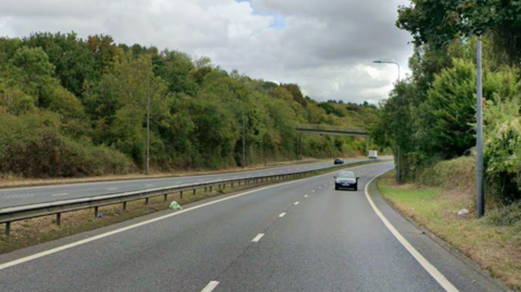 A google maps street view of the A4174 ring road near Bristol. There are trees and hedges alongside the dual carriageway and cars travelling on the road.