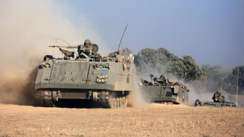 Israeli armoured personnel carriers roll towards the Israeli-Gaza border (20 July 2014)