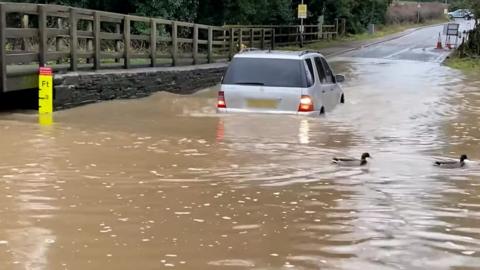 A car travelling through Rufford Lane ford