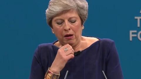 Theresa May coughing