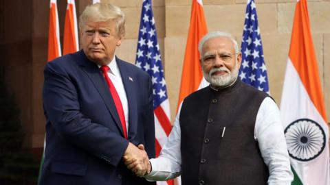 US President Donald Trump shakes hands with Indian Prime Minister Narendra Modi, as they pose for photographers at Hyderabad House in New Delhi, India, in February 2020.