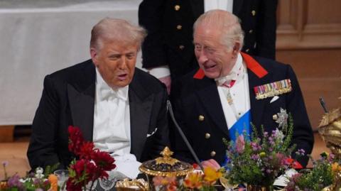 US President Donald Trump and King Charles interact at the state banquet for the US President and First Lady Melania Trump at Windsor Castle, Berkshire, on day one of their second state visit to the UK, Wednesday September 17, 2025