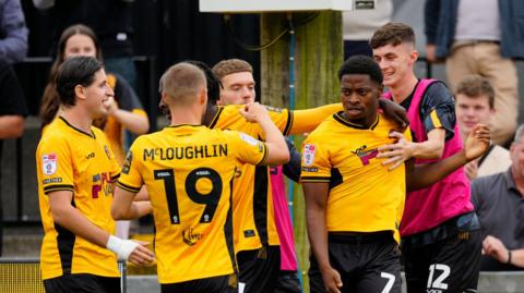 Bobby Kamwa of Newport County (7) celebrates with team mates after scoring against Doncaster Rovers