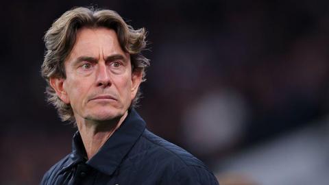 A photo of Spurs' manager Thomas Frank looking into the distance