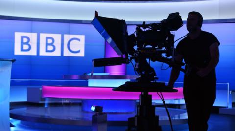 Silhouette of a camera man in a BBC Studio
