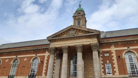 Front of Peterborough Town Hall showing four stone pillars at entrance