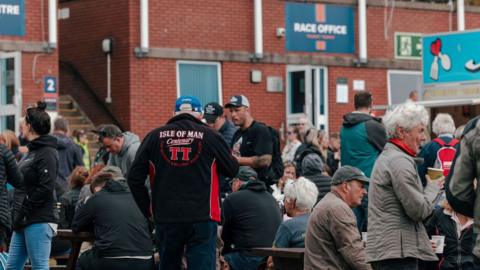 Race fans at the back of the grandstand