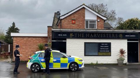 Police attending the scene at the Harvesters pub