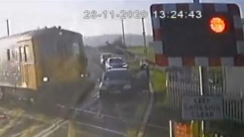 Train narrowly misses car at level crossing