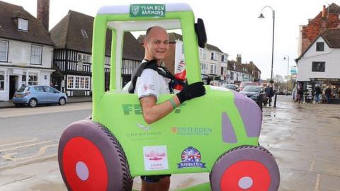 Phil Sweatman running 2.6 miles backwards dressed as a tractor