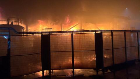 Fire behind a fence at Tata Steel plant.