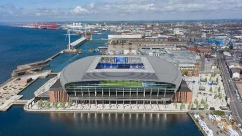 An aerial view of Everton's new football stadium showing it surrounded by docks alongside the River Mersey.