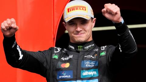McLaren's Lando Norris raises his arms in celebration after winning the British Grand Prix