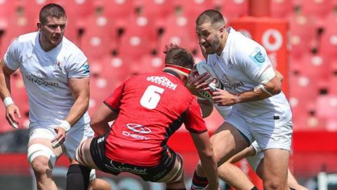 Ulster's Stuart McCloskey comes up against Lions flanker Jarod Cairns