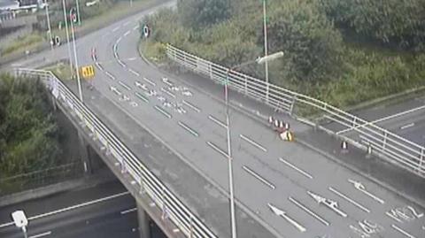 A CCTV image of the motorway bridge over the M62, it shows damage to the barrier