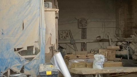 A photo of a workshop covered in dust.