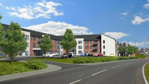 A CGI image shows what one of the buildings might look like. It is three-storey and T- shaped, with sections of white render between brown brick walls. The area in front of the building contains a ground level car park and manicured lawns with a few trees and low bushes. A road runs past the building into the distance.