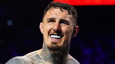 Tom Aspinall shows his gumshield 