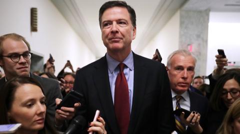 Comey is questioned by reporters outside of a congressional committee hearing in 2018