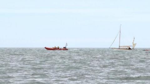The yacht being towed by Harwich Lifeboat