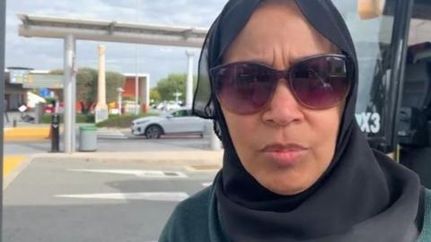 Wafaa Salim pictured outside wearing a head covering and sunglasses