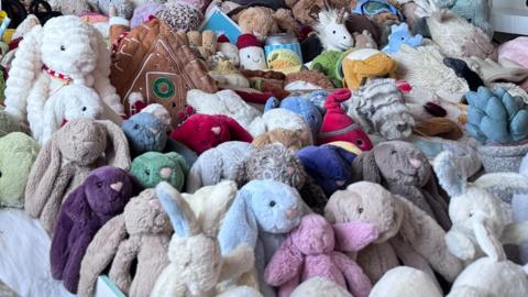 A huge pile of Jellycat toys, many of which resembling bunny rabbits