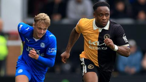 Udoka Godwin-Malife of Burton Albion in action against Harley Mills of Peterborough United