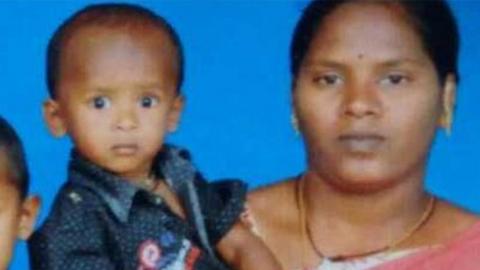 Sujith on his mother's arm with his brother and father