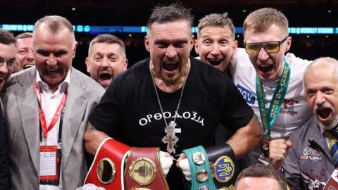 Oleksandr Usyk celebrates beating Daniel Dubois with his support team