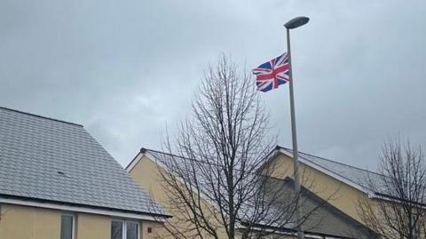 A row of houses in Cranbrook with a Union flag on a lamppost